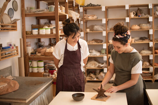Two friends taking a sculpture class together
