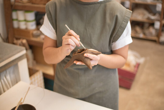 Hands of a Woman Modelling Clay