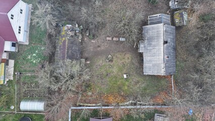 Vertical view of an old wooden gray hut, a dilapidated dwelling of past twentieth century construction.  Abandoned land, abandoned village, town. Dying town, village.