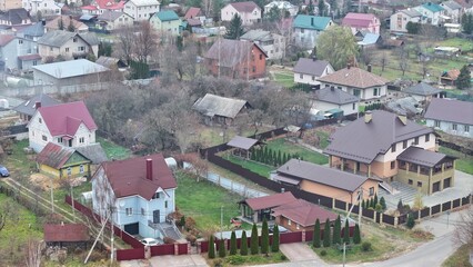 Fototapeta premium The modern village in Eastern Europe. Cottage village with private development, plots, one- and two-storey houses. Countryside housing near the city in Europe.