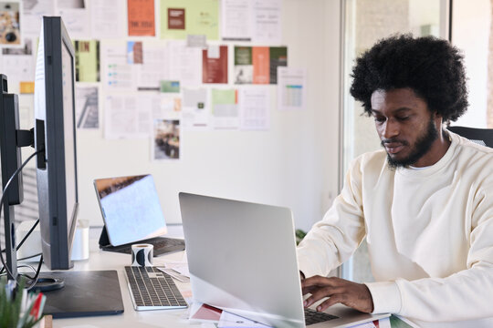Creative designer sitting at the desk of his creative studio typ