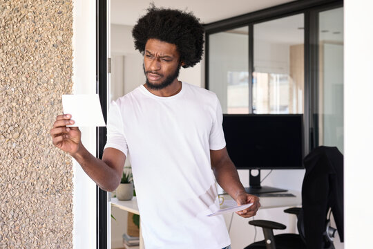 Serious frown businessman looking at pictures