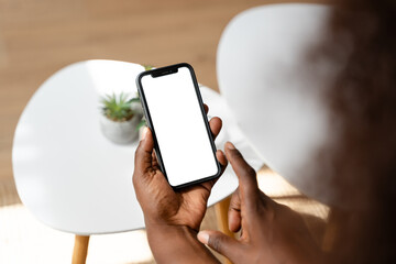 Person holding smartphone with blank white screen