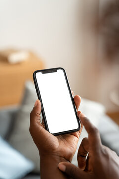 Man browsing internet on smartphone with white blank screen at home