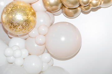 White and gold balloons with confetti  on a white background are creating an elegant and festive atmosphere. Background. Festive background. 