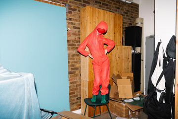 Quirky Figure in Red Suit Against a Colorful Background