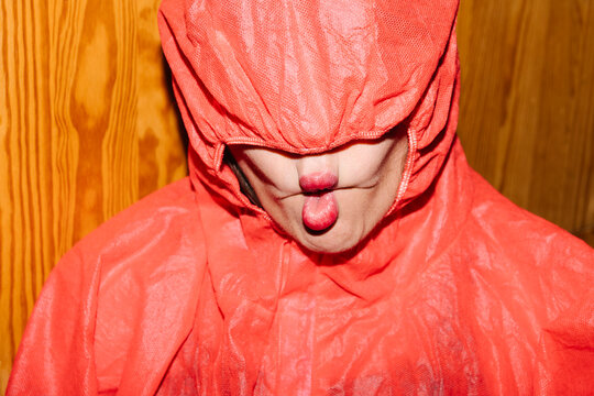 Person in Red Cloak Making a Playful Fish Face