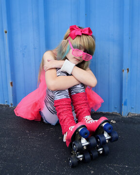 Eighties Girl Sitting Down with Roller Skates
