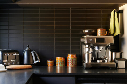 Modern kitchen countertop featuring a coffee machine and stylish decor