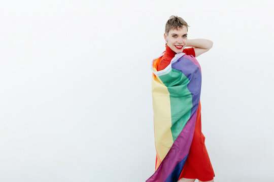 Happy gender fluid person with LGBT flag
