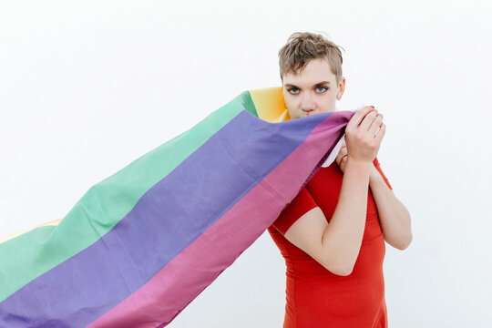 Confident non binary character with rainbow flag