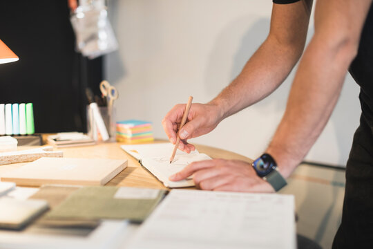 Hands sketching and collaborating on a design project