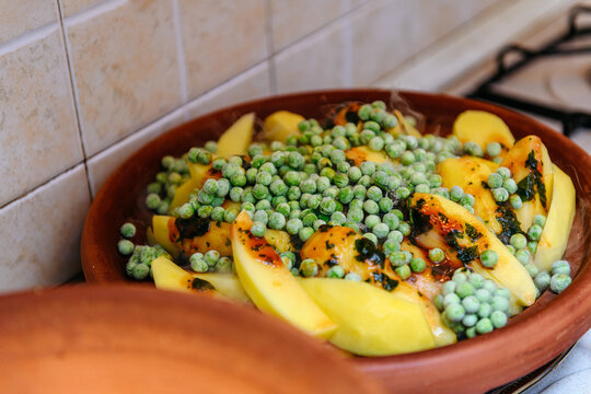 Traditional moroccan dish tajine with raw ingredients