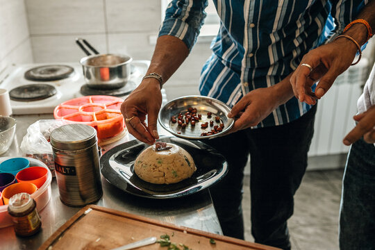 Indian students cooking upma at the hostel kitchen together.
