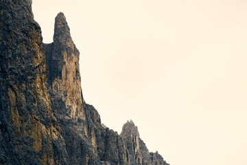 Majestic rocky cliffs rise high against a soft sky at twilight capturing the natural beauty of the landscape