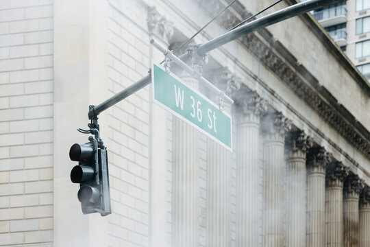 Misty traffic light on W 36 St in NYC with classic architecture