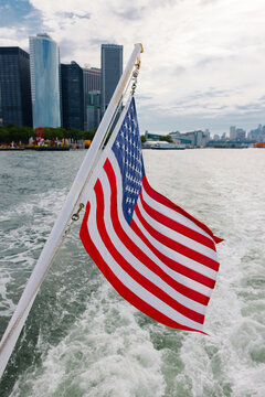 American flag on boat with New York City skyline in the backgrou
