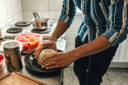 Indian student cooking upma at the hostel kitchen.