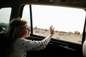A girl in a car in the desert