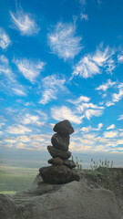 Stacked stones under a serene sky, a perfect metaphor for balance and peace.