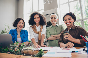 Photo of lovely four businessladies meeting community brainstorming business plan startup meeting office interior