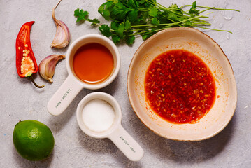 Thai chili sauce and ingredients for its preparation, chili pepper, garlic, lime