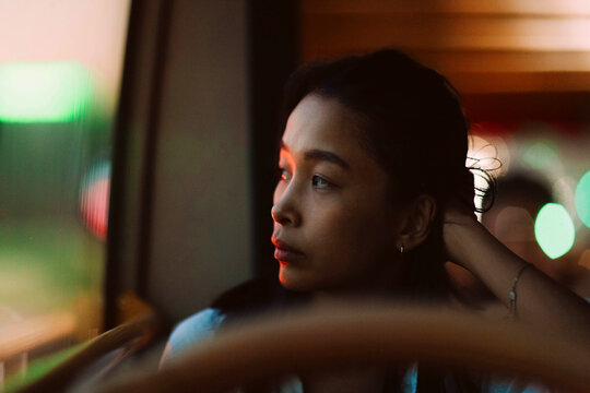 young girl looking out the bus window