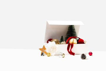 A box of Christmas ornaments on white background