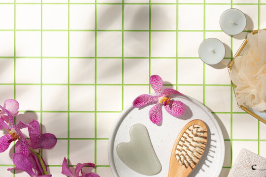 Spa Elements on Green Tiled Surface With Flowers and Candles