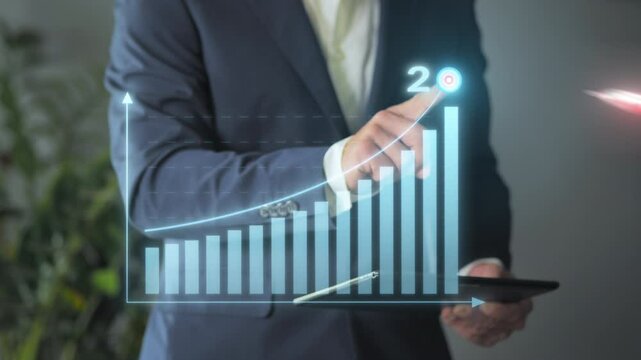 2025 business target achievement,businessman standing drawing growing profit graphic chart on virtual screen,new year outcome reaching  goal,corporate growth development