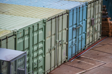 Old shipping containers serve as storage and workshop in an industrial area. Used for worldwide...