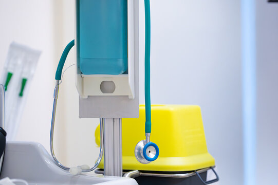 Stethoscope hangs over a disinfection pump used by a doctor to listen to a patient's internal sounds. Intensive care room for patient surveillance.