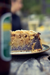 Delicious slice of traditional dessert served with a refreshing drink at an outdoor gathering during a sunny afternoon