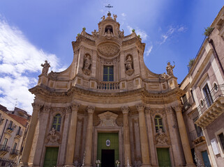 Catania, Basilica della Collegiata low angle view facade under sunny blue sky, Sicily, Italy. 