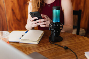 Unrecognizable person using electronic devices at home.