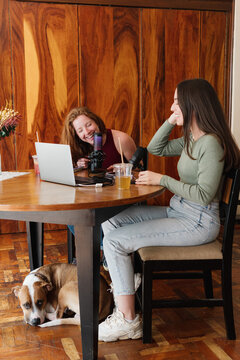 Women having fun while podcasting at home.