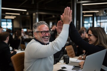 Team Members Celebrate Success with High-Fives in Modern Office