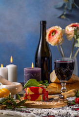 Colorful cheese with wine, bread and lit candles creating romantic atmosphere