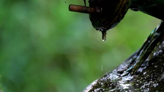Leaking water pipe. Water drips continuously. Imperfect pipe connections. Real time, raw video no edit. Footage 4K,60Fps