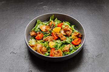 Fresh chicken salad with lettuce, cherry tomatoes, and citrus, perfect for a light and healthy meal