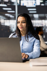 Professional business developer engages in project management at her desk, working on multinational company growth. Worker focusing on strategy planning to drive corporate success.