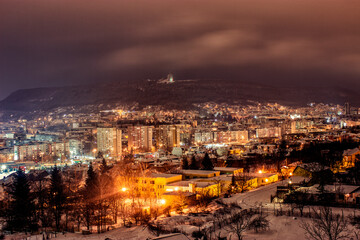 Misty Winter Evening Over Shumen: A Blend of Warm and Cool Lights in a Bulgarian City