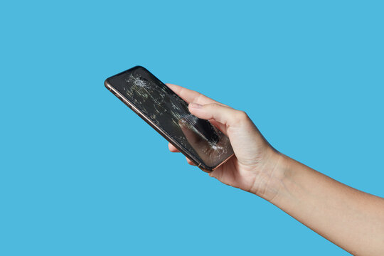 Unknown human holding black cellphone with destructed glass