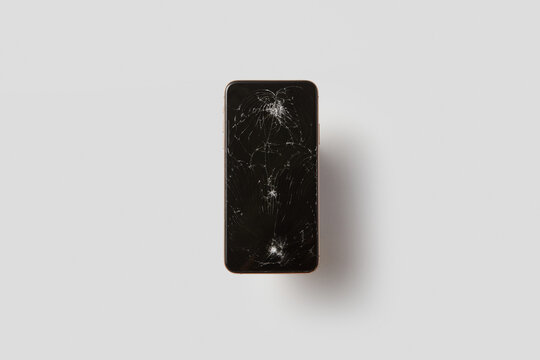 Black cellular phone with broken glass with sharp fragments