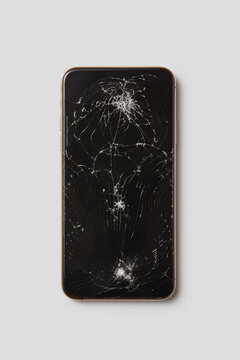 Turned off smartphone with marks from hits on touchscreen