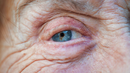Close-up of a deep blue eye of an older woman.