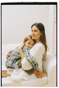 Tender Embrace Between Mother and Daughter at Home