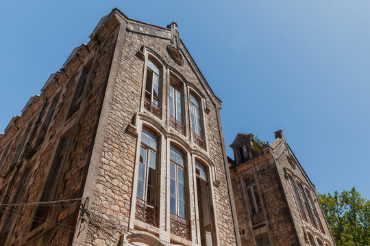A low-angle view of a historic stone abandoned building