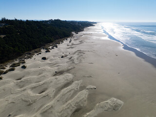 Bright sunlight shines on Agate Beach situated along the Oregon Coast Highway in the town of Newport. The beautiful beach is named after its abundance of iron oxide-colored agates found there.