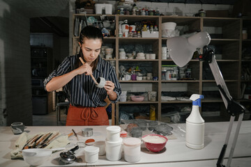 Artist skillfully shapes pottery in a studio during a creative session